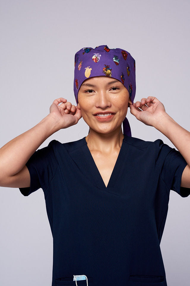 A doctor wearing a Dr. Woof 15 Hearts by Sarai Llamas Surgical Scrub Cap