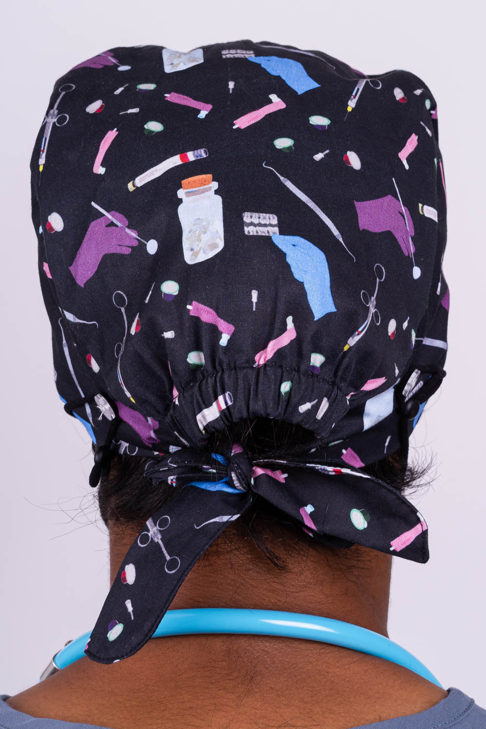 A Doctor Wearing a Dr. Woof Sugar Skulls Anesthesia Surgical Scrub Cap 