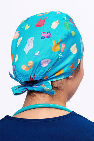 A Nurse wearing a Dr. Woof Goo Goo Gaa Gaa Surgical Scrub Cap 
